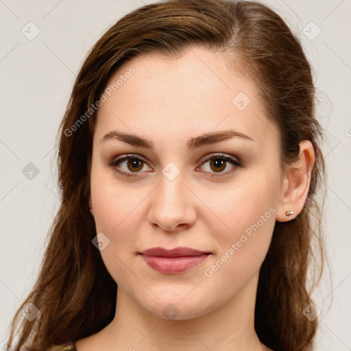 Joyful white young-adult female with long  brown hair and green eyes