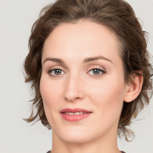 Joyful white young-adult female with medium  brown hair and green eyes