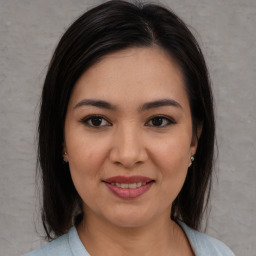 Joyful asian young-adult female with medium  brown hair and brown eyes