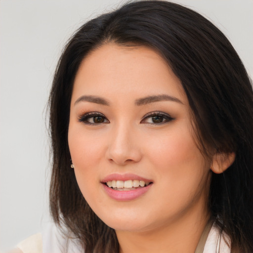 Joyful asian young-adult female with long  brown hair and brown eyes