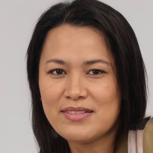 Joyful asian adult female with long  brown hair and brown eyes