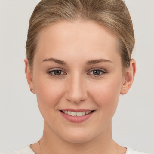 Joyful white young-adult female with short  brown hair and grey eyes