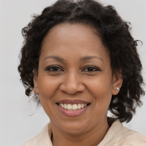 Joyful black adult female with medium  brown hair and brown eyes