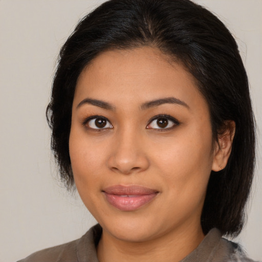 Joyful asian young-adult female with medium  brown hair and brown eyes