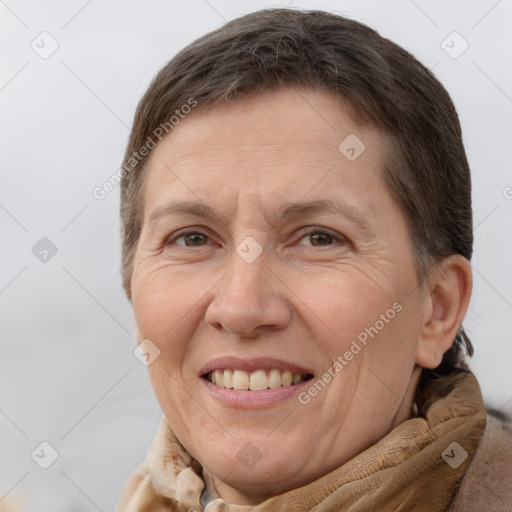 Joyful white adult female with short  brown hair and brown eyes