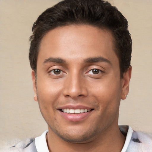 Joyful white young-adult male with short  brown hair and brown eyes