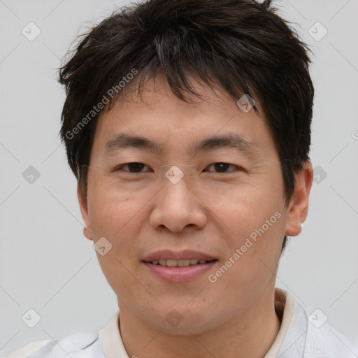 Joyful asian young-adult male with short  brown hair and brown eyes