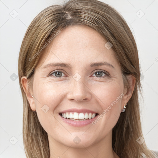 Joyful white young-adult female with long  brown hair and grey eyes