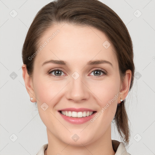 Joyful white young-adult female with medium  brown hair and grey eyes