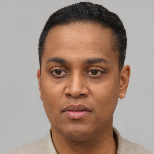 Neutral latino young-adult male with short  black hair and brown eyes