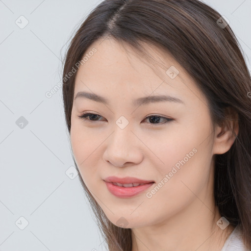 Joyful asian young-adult female with long  brown hair and brown eyes