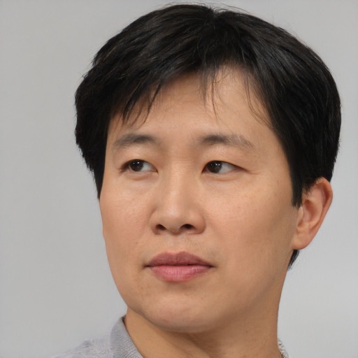 Neutral asian adult male with short  black hair and brown eyes