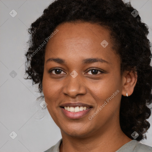 Joyful black young-adult female with medium  black hair and brown eyes