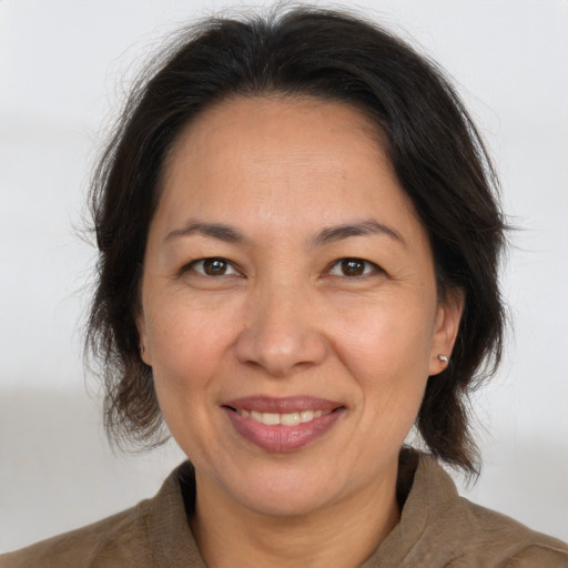 Joyful white adult female with medium  brown hair and brown eyes