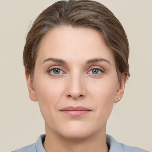 Joyful white young-adult female with short  brown hair and grey eyes