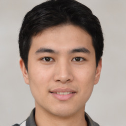 Joyful asian young-adult male with short  black hair and brown eyes