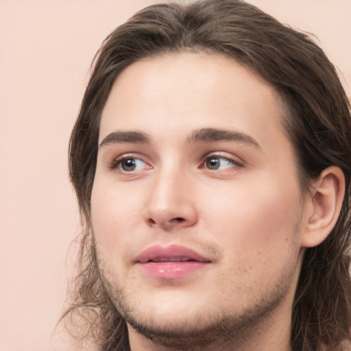 Neutral white young-adult male with long  brown hair and brown eyes