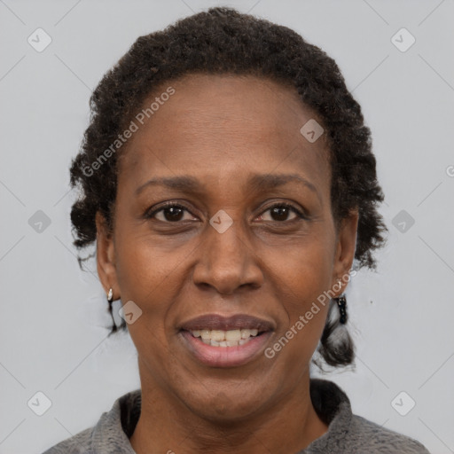 Joyful black adult female with short  brown hair and brown eyes