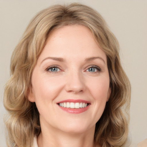 Joyful white young-adult female with medium  brown hair and green eyes