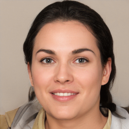 Joyful white young-adult female with medium  brown hair and brown eyes