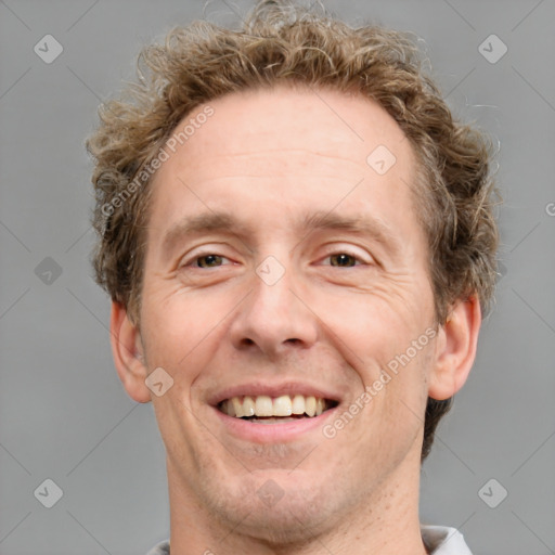 Joyful white adult male with short  brown hair and grey eyes