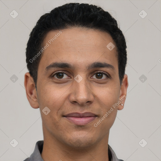 Joyful latino young-adult male with short  brown hair and brown eyes