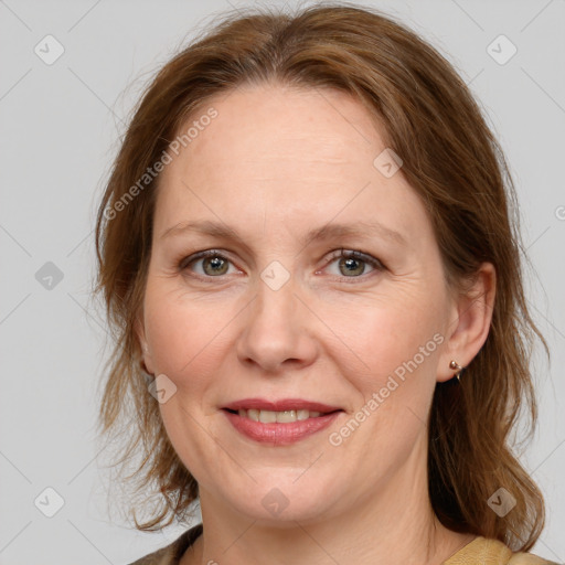 Joyful white adult female with medium  brown hair and grey eyes