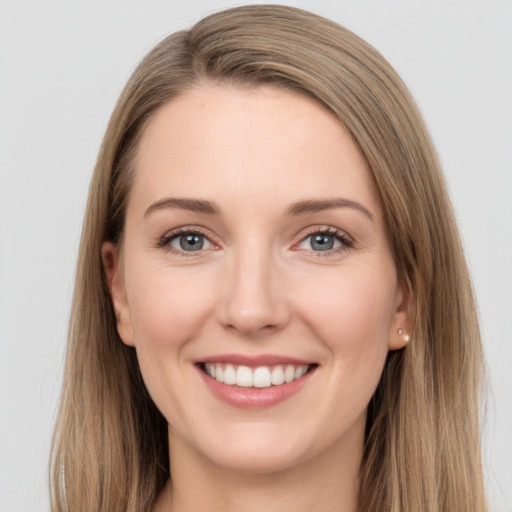 Joyful white young-adult female with long  brown hair and grey eyes