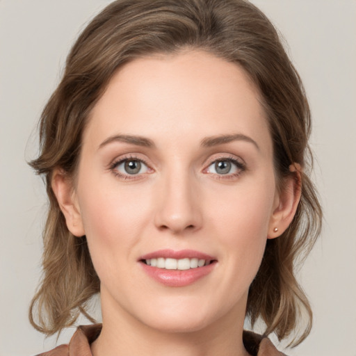 Joyful white young-adult female with medium  brown hair and grey eyes