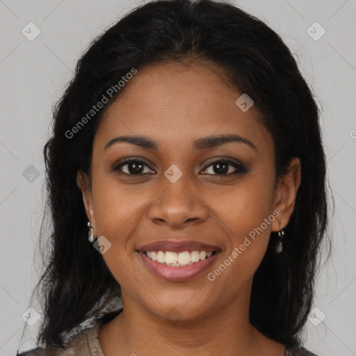 Joyful black young-adult female with long  brown hair and brown eyes