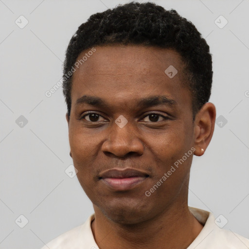 Joyful black young-adult male with short  black hair and brown eyes