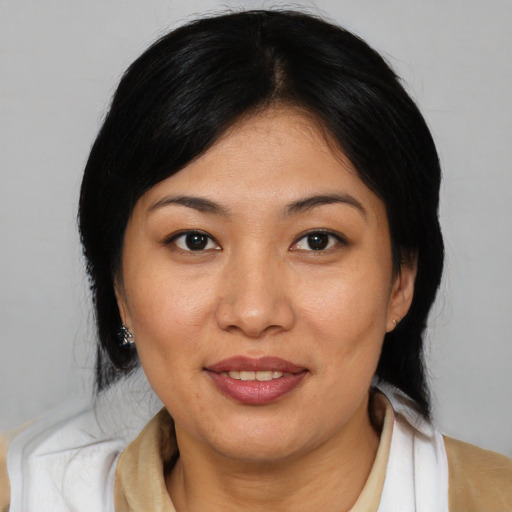 Joyful asian young-adult female with medium  brown hair and brown eyes