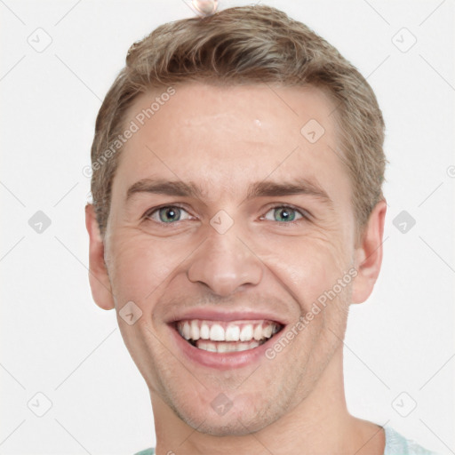 Joyful white young-adult male with short  brown hair and grey eyes