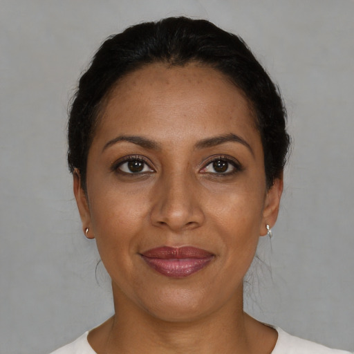 Joyful black adult female with short  black hair and brown eyes