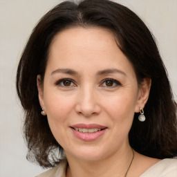 Joyful white adult female with medium  brown hair and brown eyes