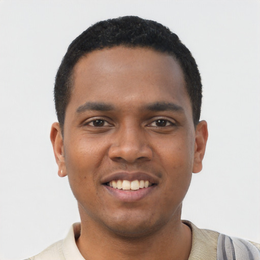 Joyful black young-adult male with short  black hair and brown eyes