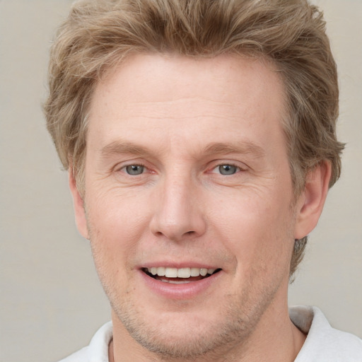 Joyful white adult male with short  brown hair and grey eyes