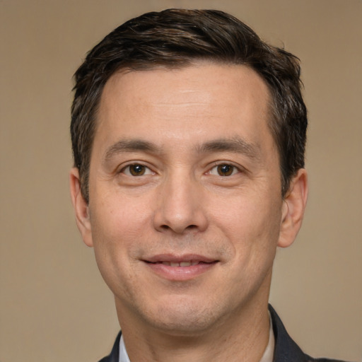 Joyful white adult male with short  brown hair and brown eyes