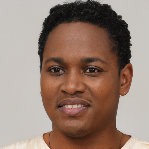 Joyful black young-adult female with short  black hair and brown eyes