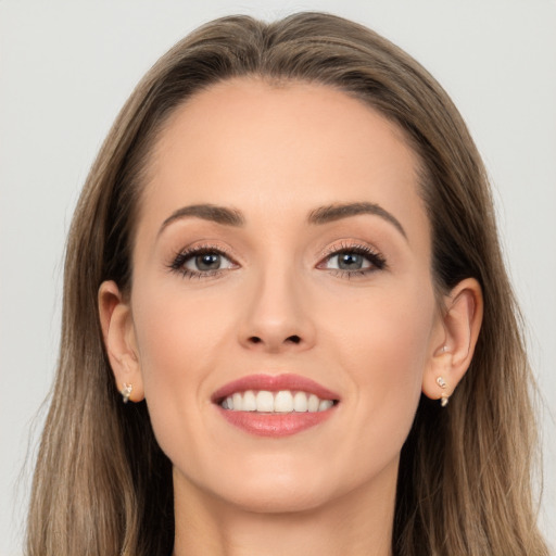 Joyful white young-adult female with long  brown hair and brown eyes