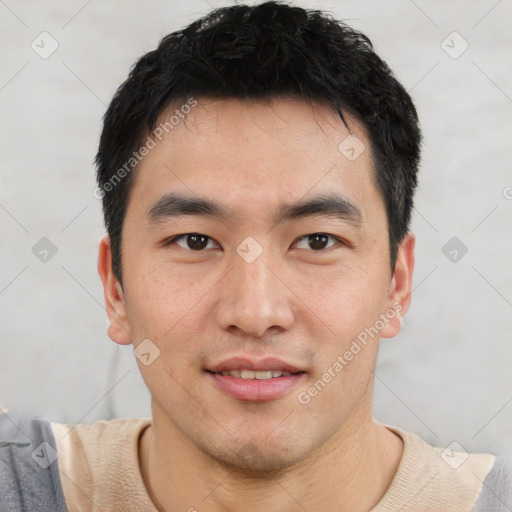 Joyful asian young-adult male with short  black hair and brown eyes