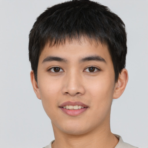 Joyful asian young-adult male with short  black hair and brown eyes