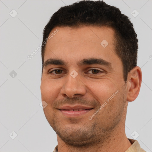 Joyful white young-adult male with short  black hair and brown eyes