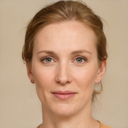 Joyful white young-adult female with medium  brown hair and green eyes