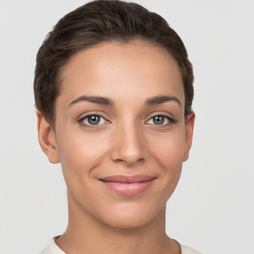 Joyful white young-adult female with short  brown hair and brown eyes