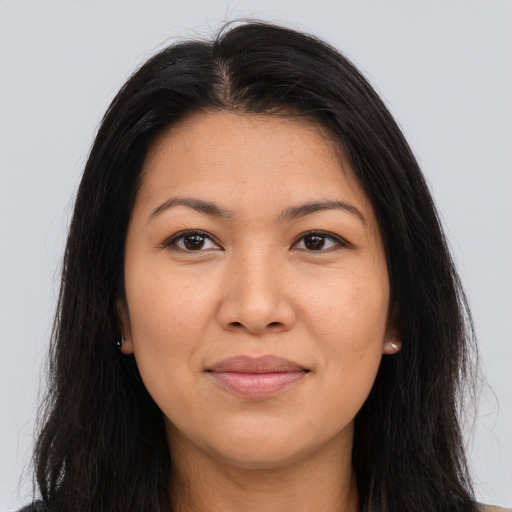 Joyful asian young-adult female with long  brown hair and brown eyes