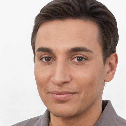 Joyful white young-adult male with short  brown hair and brown eyes