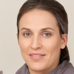 Joyful white adult female with long  brown hair and brown eyes