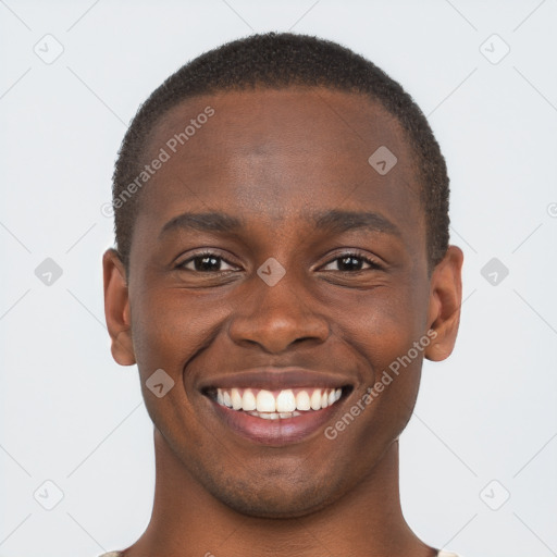 Joyful black young-adult male with short  brown hair and brown eyes