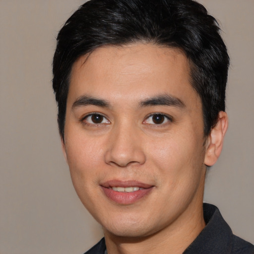 Joyful asian young-adult male with short  black hair and brown eyes